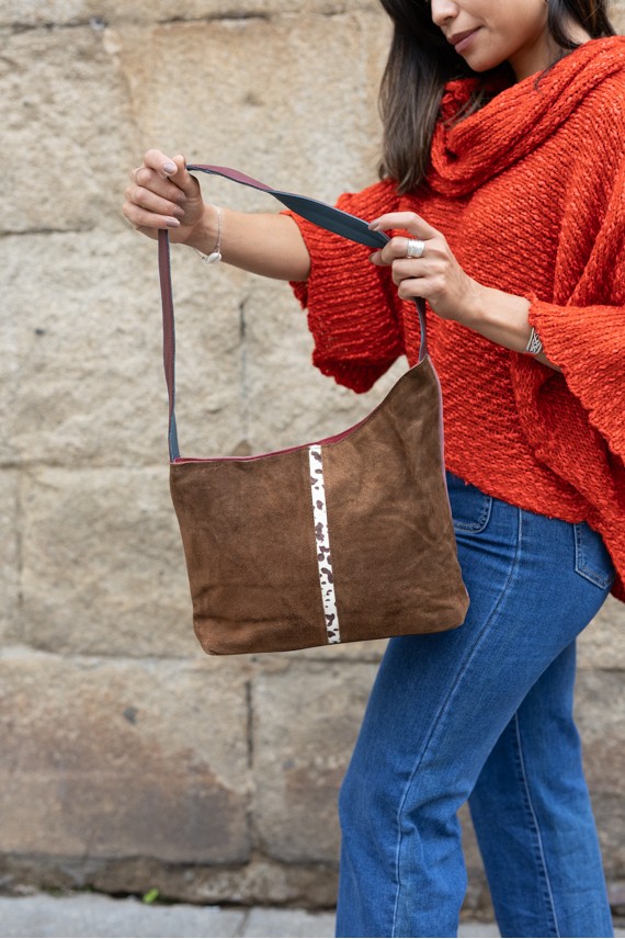 Bolso Noelia Soruka reversible de ante reciclado, con cara rosa y cara marrón con detalle animal print, artesanía sostenible.