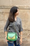 “Bolso Cher Soruka de piel reciclada en colores verde, azul y rojo, diseño artesanal sostenible con lengüeta reversible.”