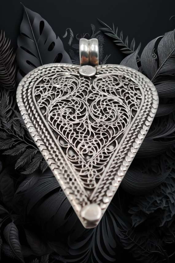 Colgante corazón artesanal en plata de ley 925 con acabado antiguo y filigrana hecha a mano.