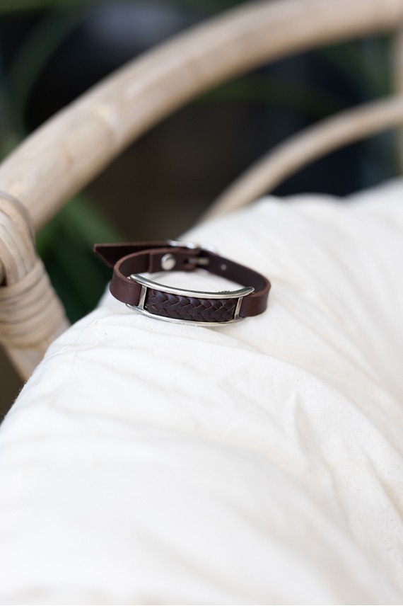 Pulsera Tierra de cuero marrón con trenzado central y marco metálico plateado de estilo boho.