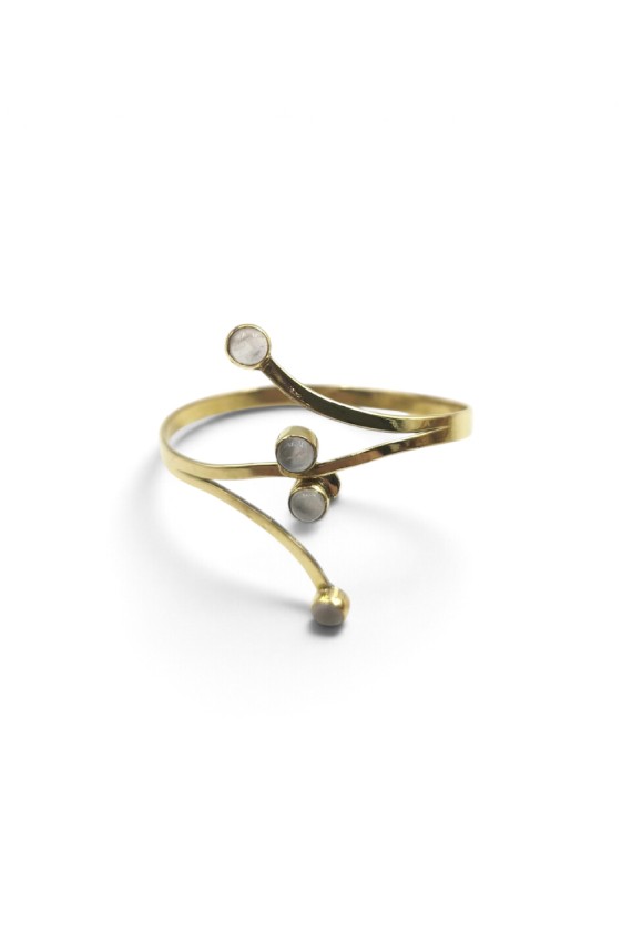 Brazalete rígido dorado con cuatro piedras de cuarzo cristal y líneas curvas de estilo bohemio.